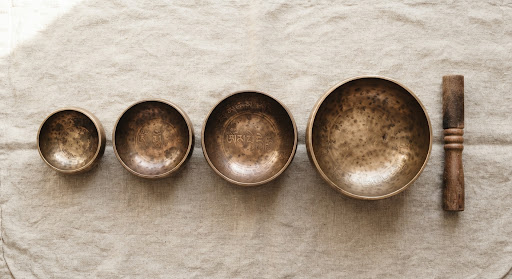 Hand-hammered Himalayan singing bowls on linen